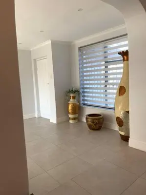 a room with three large vases sitting on a tile floor at Villa Lamsyh- your second home in Cape Town