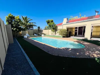 a swimming pool in the yard of a house at 4 Bedroom Bliss in Cape Town