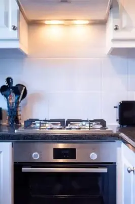 a kitchen with a stove top oven in a kitchen at Cosy Home in Claremont in Cape Town