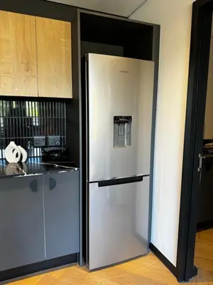 a white refrigerator in a kitchen next to a counter at S.A.E. Nine Palms Luxury in Cape Town