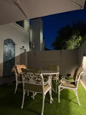 a table and chairs on a patio at night at La Gratitude 8 luxury in Stellenbosch CENTRAL in Stellenbosch