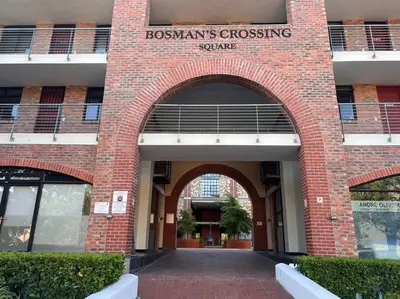 a brick building with a sign that reads bosams crossing square at Ben's Apartment in Stellenbosch