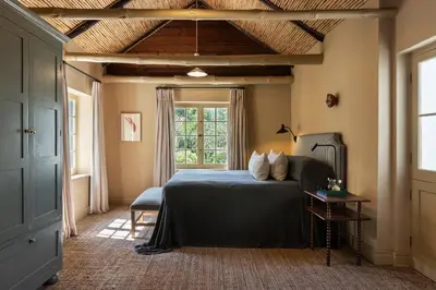 a bedroom with a bed and a window at Boschendal Farm Estate in Franschhoek