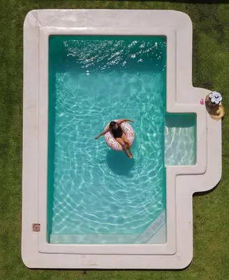 a person swimming in a pool in the water at Menuha Hermanus in Hermanus