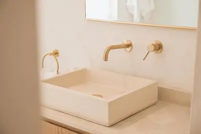 a white sink in a bathroom with a mirror at Menuha Hermanus in Hermanus