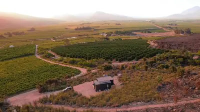 an aerial view of a farmhouse in the middle of a field at Springsteen Cabins in Rawsonville