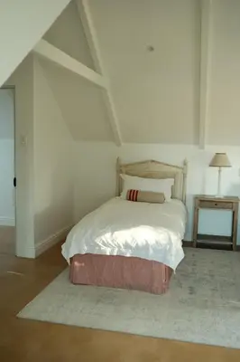 a bedroom with a bed with a white bedspread at Gabriëlskloof Farm House in Botrivier