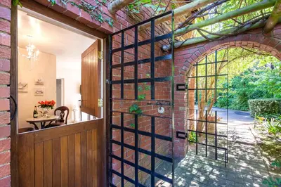an entrance to a brick building with an archway at Devon Castle Orchard Cottage in Stellenbosch