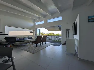 a living room with a couch and a table and chairs at 116m² SeaView TopLuxury Apart, Bay & Mountain View in Somerset West