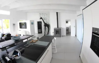 a white kitchen with a giraffe on the wall at 116m² SeaView TopLuxury Apart, Bay & Mountain View in Somerset West
