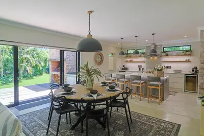 a kitchen and dining room with a table and chairs at Saffron House in Hermanus