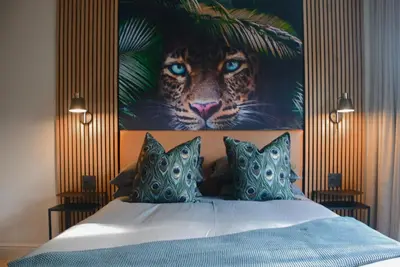 a bedroom with a painting of a tiger on the wall at Luxery Gem in Stellenbosch in Stellenbosch
