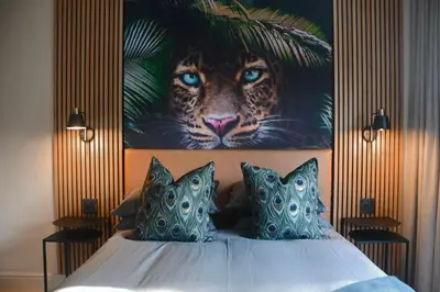 a bedroom with a painting of a tiger on the wall at Luxery Gem in Stellenbosch in Stellenbosch
