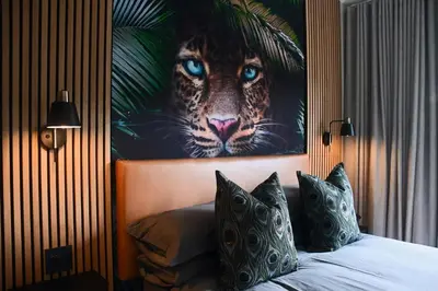 a bedroom with a painting of a tiger on the wall at Luxery Gem in Stellenbosch in Stellenbosch