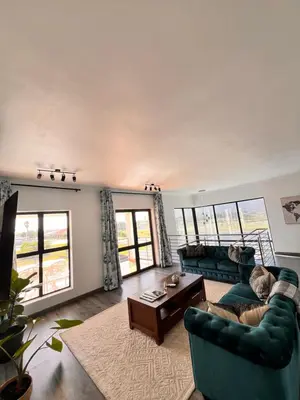 a living room with a couch and a table at 2nd on Strand in Cape Town