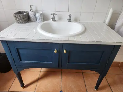a bathroom with a sink and a blue cabinet at Stirling House in Paarl