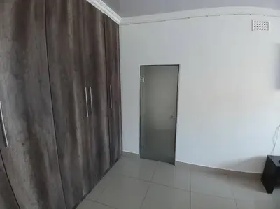 a room with wooden cabinets and a door at One bedroom apartment. in Cape Town