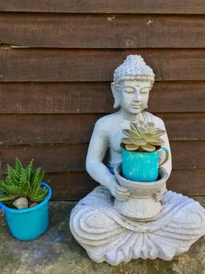 a statue of a person holding a potted plant at Gypsy Mama in Greyton in Greyton