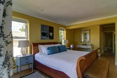 a bedroom with a large bed and a window at Dieu Donne in Hermanus