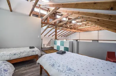 a room with two beds and a loft at The Neighbours - Kleinmond in Kleinmond