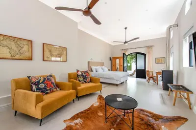 a living room with two couches and a couch at Franschhoek Colours in Franschhoek