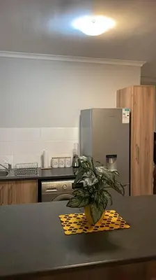 a kitchen with a table with a potted plant on a counter at Modest Home in Cape Town in Cape Town