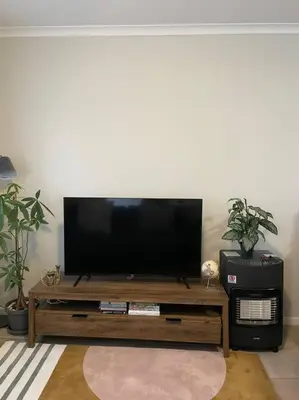 a flat screen tv sitting on top of a wooden table at Modest Home in Cape Town in Cape Town