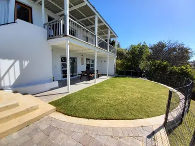 a backyard of a house with a fence at 'BoStrand' - Private and Central, only 2 min walk to beach - sleeps 2 in Gordonʼs Bay