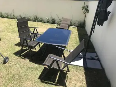 a blue picnic table and chairs in a yard at Luxurious Lifestyle in Cape Town