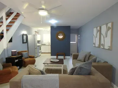 a living room with a couch and a table at 'Terrace-On-Sea'- 2 Min from the beach, 2 bedroom town house, Sleeps 4 in Cape Town