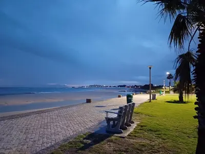 a row of benches sitting on a beach at 'Terrace-On-Sea'- 2 Min from the beach, 2 bedroom town house, Sleeps 4 in Cape Town