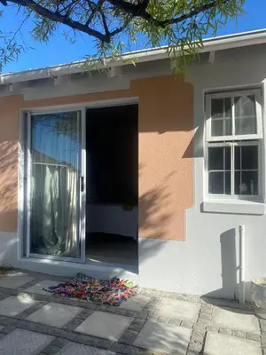 a house with its door open and a pile of trash outside at Freys 1 in Cape Town