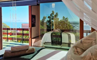 a bedroom with a bed and a large glass window at 'The Loft', 2 bedroom, sleeps 4, Central, Fantastic Views! in Cape Town