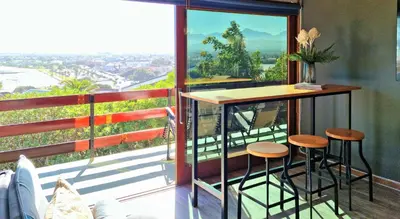 a balcony with a bar with a view of the city at 'The Loft', 2 bedroom, sleeps 4, Central, Fantastic Views! in Cape Town