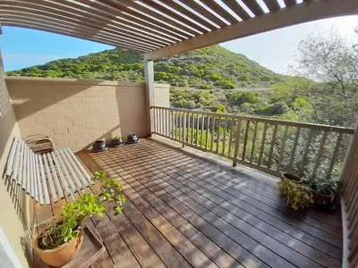 a balcony with a view of a mountain at Peaceful Seaside Cottage, Betty's Bay Accommodation in Clareport