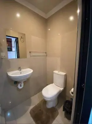 a bathroom with a toilet and a sink at Victoria Lodge Studio Apartment in Cape Town