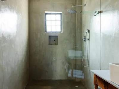 a bathroom with a shower and a sink at Nooitgedacht Guest Farm Cottages in Kayamnandi