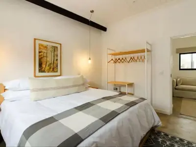 a bedroom with a large bed in a room at Nooitgedacht Guest Farm Cottages in Kayamnandi