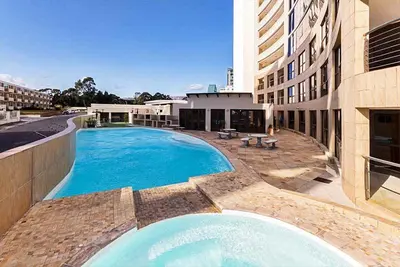 a large swimming pool in front of a building at 302 Ocean View in Strand