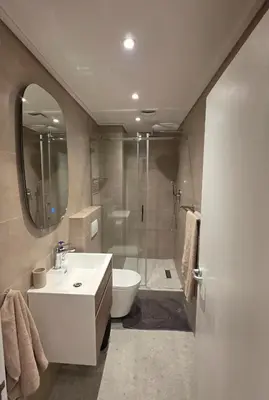 a bathroom with a sink and a toilet and a shower at Happy Dolphin - Luxury 3BR Sea View Apartment in Cape Town