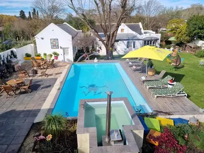 a swimming pool in the backyard of a house at Greyton Toad Hall Historic Private House in Central Greyton in Greyton