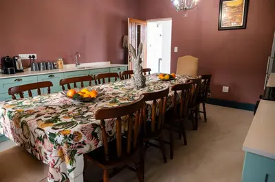 a dining room with a table and chairs in a kitchen at Greyton Toad Hall Historic Private House in Central Greyton in Greyton