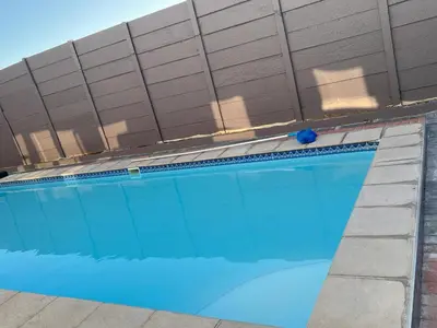 a large swimming pool in front of a building at Pemba's residence in Cape Town