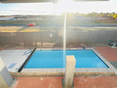 a swimming pool with a fountain in a parking lot at Pemba's residence in Cape Town