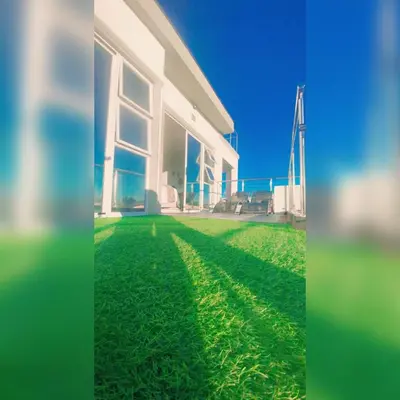 a house with a green lawn in front of it at Kwaaamiii in Cape Town