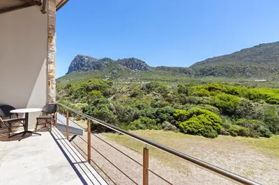 a balcony with a view of the mountains at Hangklip Villa in Pringle Bay