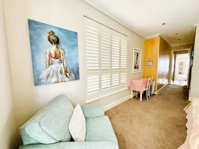 a living room with a couch and a painting on the wall at 74 on Marine - Apartment 303 in Hermanus