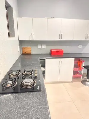 a kitchen with a black stove top in a kitchen at Malaika Guest House in Cape Town
