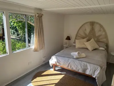 a bedroom with a bed with two towels on it at Fantastic spot In Hermanus with great lagoon views in Hermanus