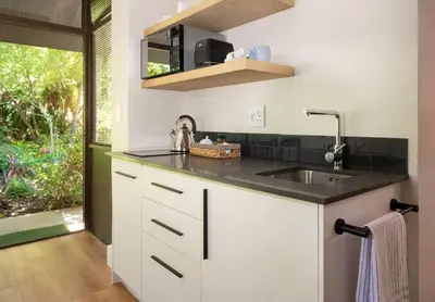 a white kitchen with a sink and a window at The Oasis of Stellenbosch in Stellenbosch